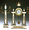 An elegant white and grey marble French Louis XVI style mantel clock with candelabra. Ca 1900. €. 2.000,-